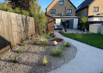 Curving gravel garden border with ornamental grasses.