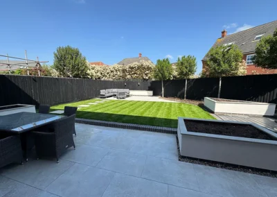 Bespoke rendered garden planters with porcelain coping.
