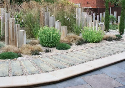 Upright timbers with ornamental grasses.