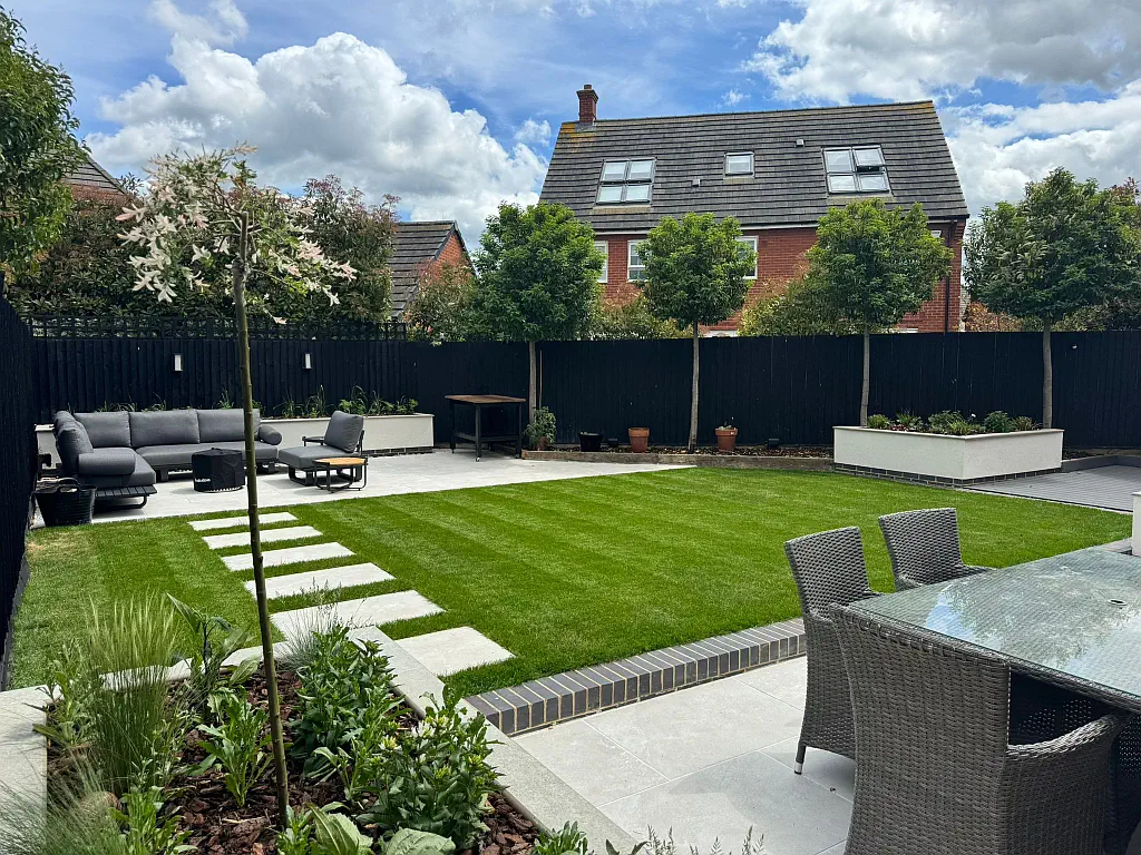 Lawn with split level porcelain paving.